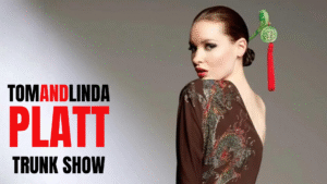 Tom and Linda Platt trunk show text with woman looking over her shoulder